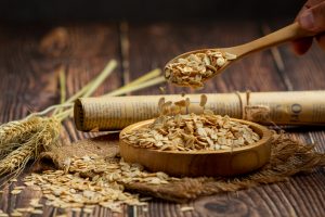 raw barley grain in wooden background